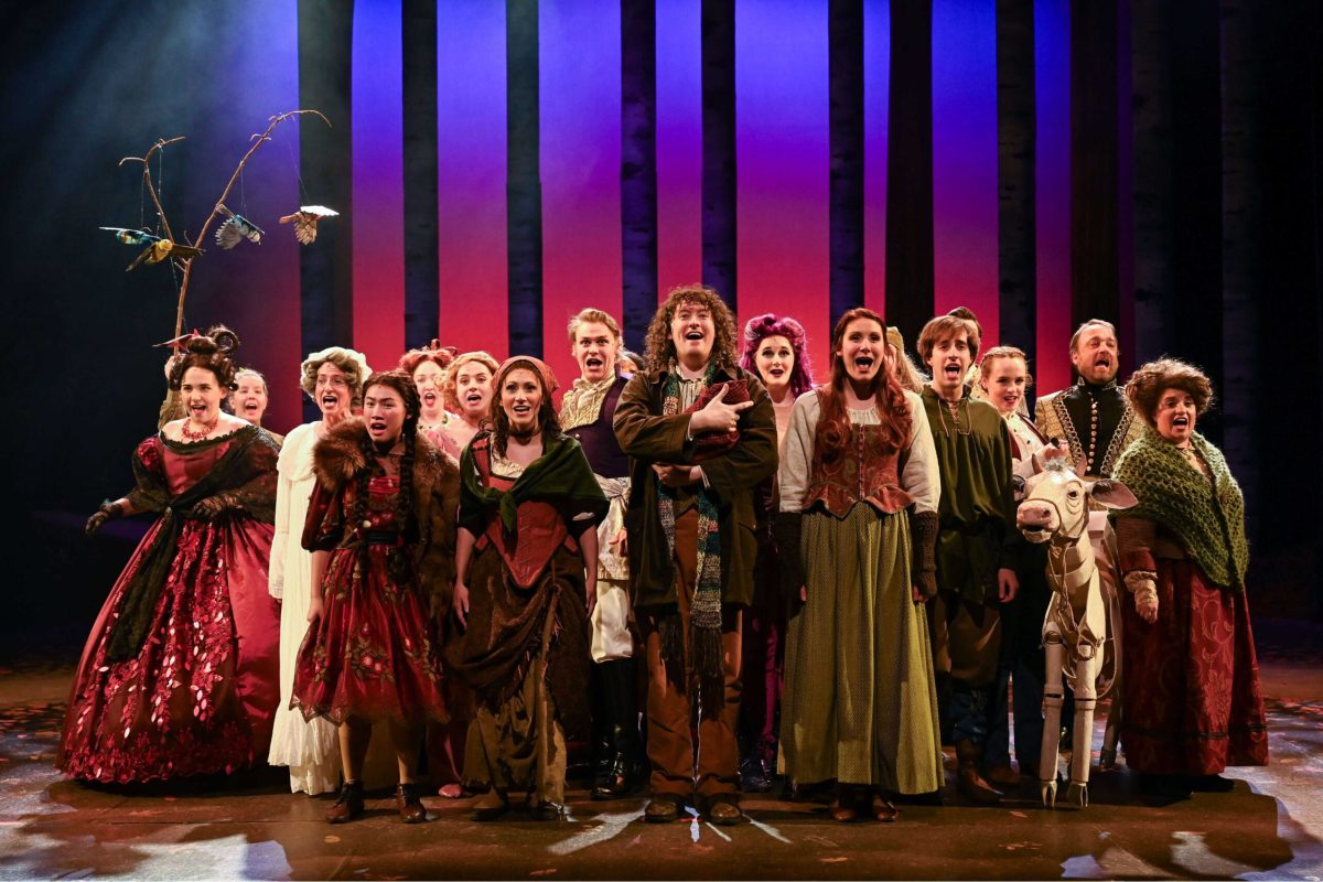 A large group of individuals facing out and singing.