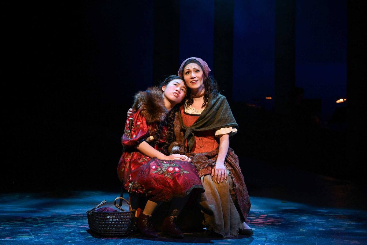 Two women sitting and hugging.