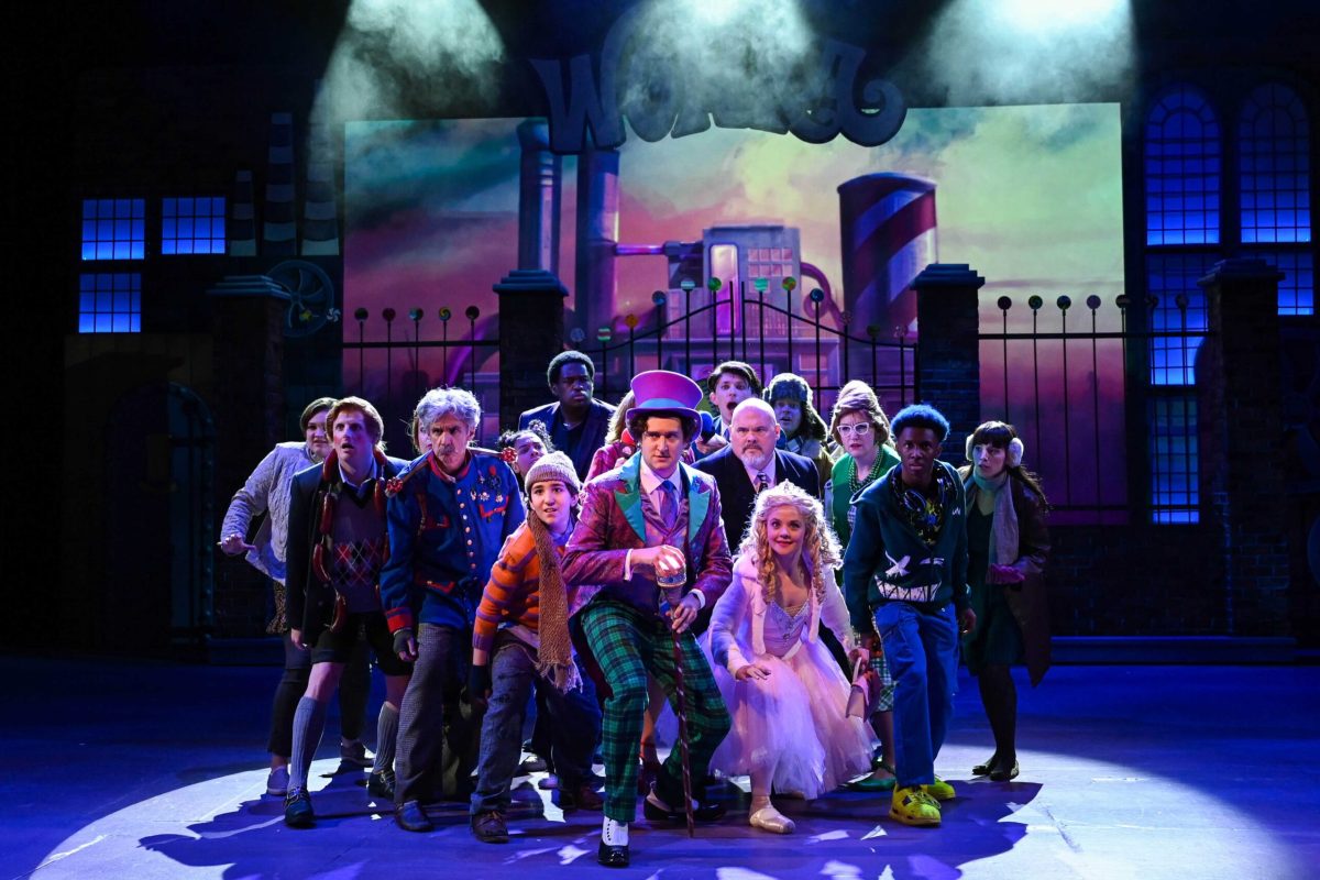 A group of townsfolk circled around Willy Wonka.