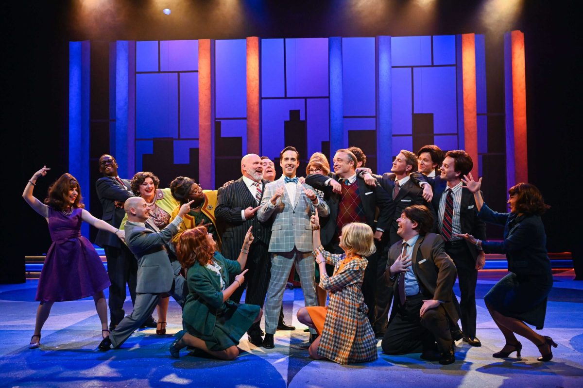 One man surrounded by fellow coworkers.